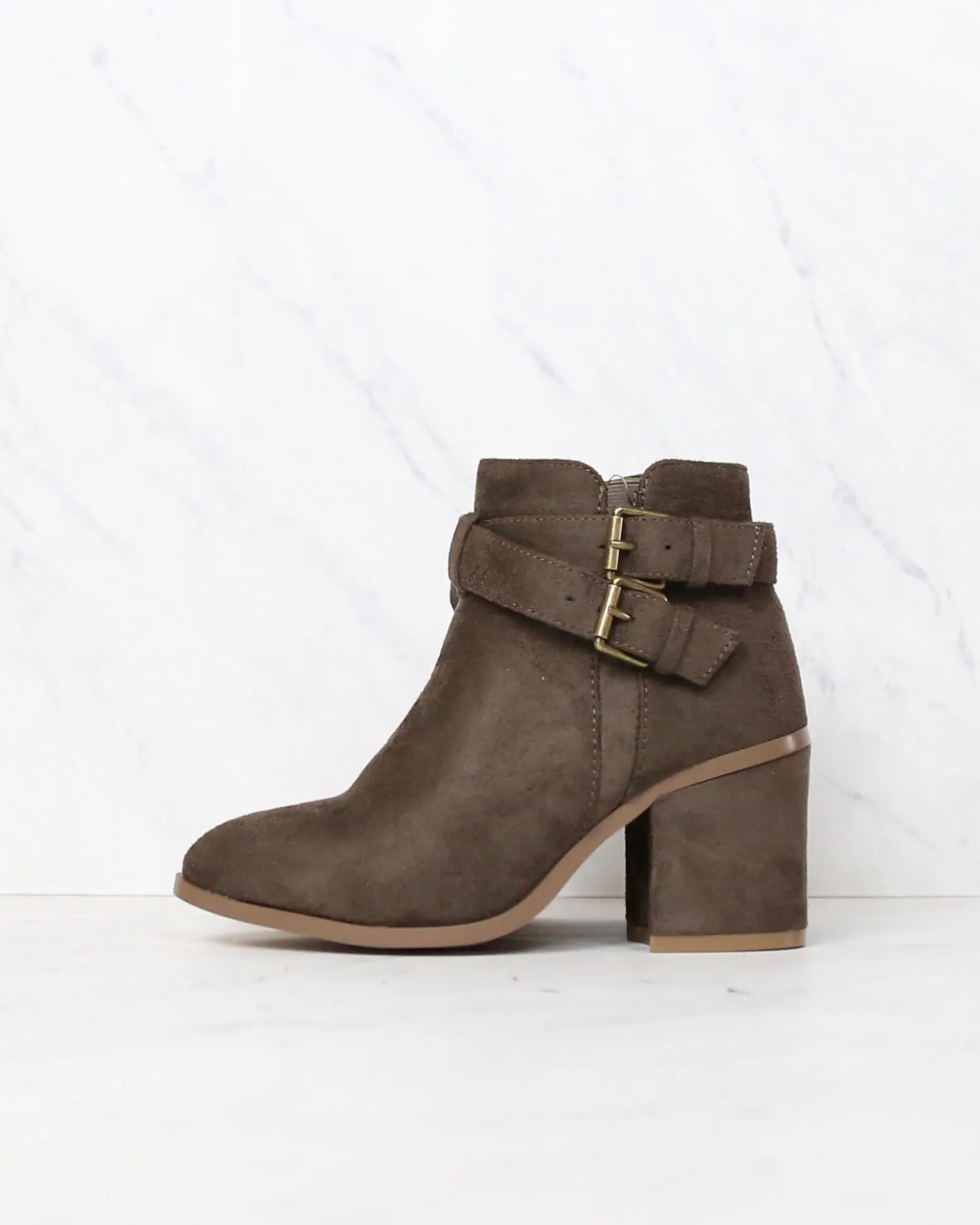 A Grand Entrance Faux Suede Ankle Bootie With Buckle Detail in More Colors